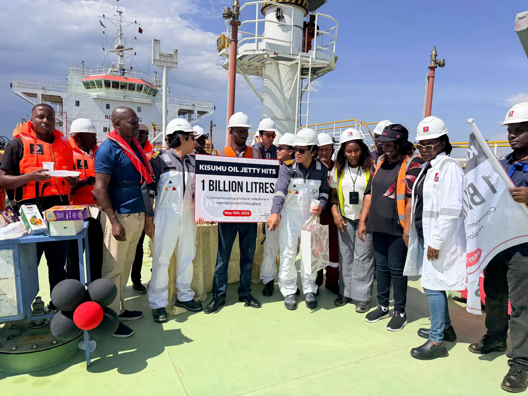 Team holding the one billion litres banner